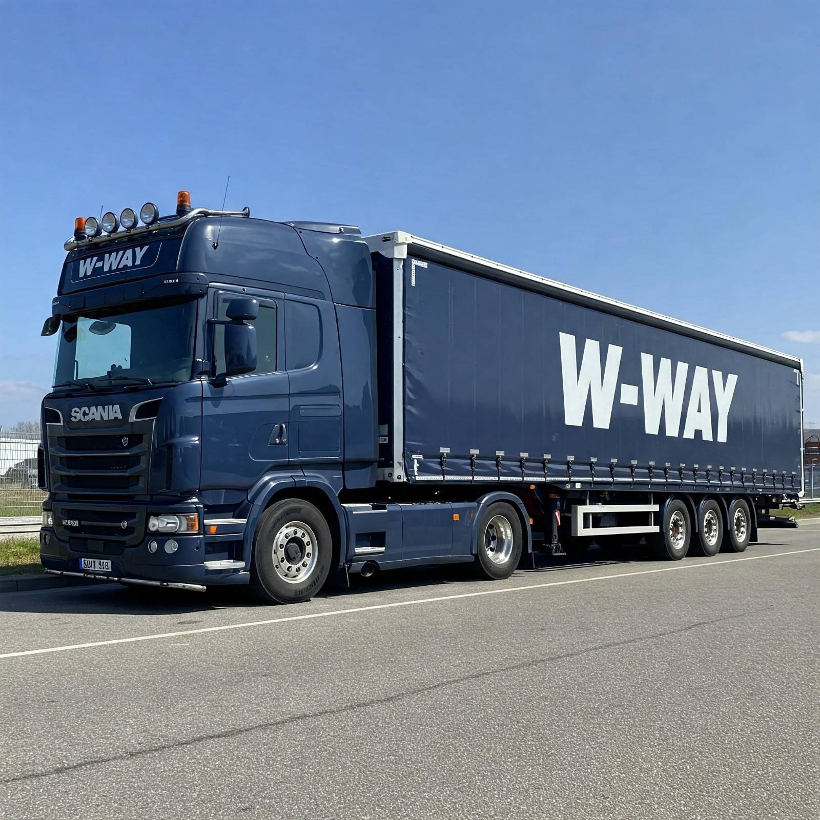 Niebieska ciężarówka W-WAY na drodze